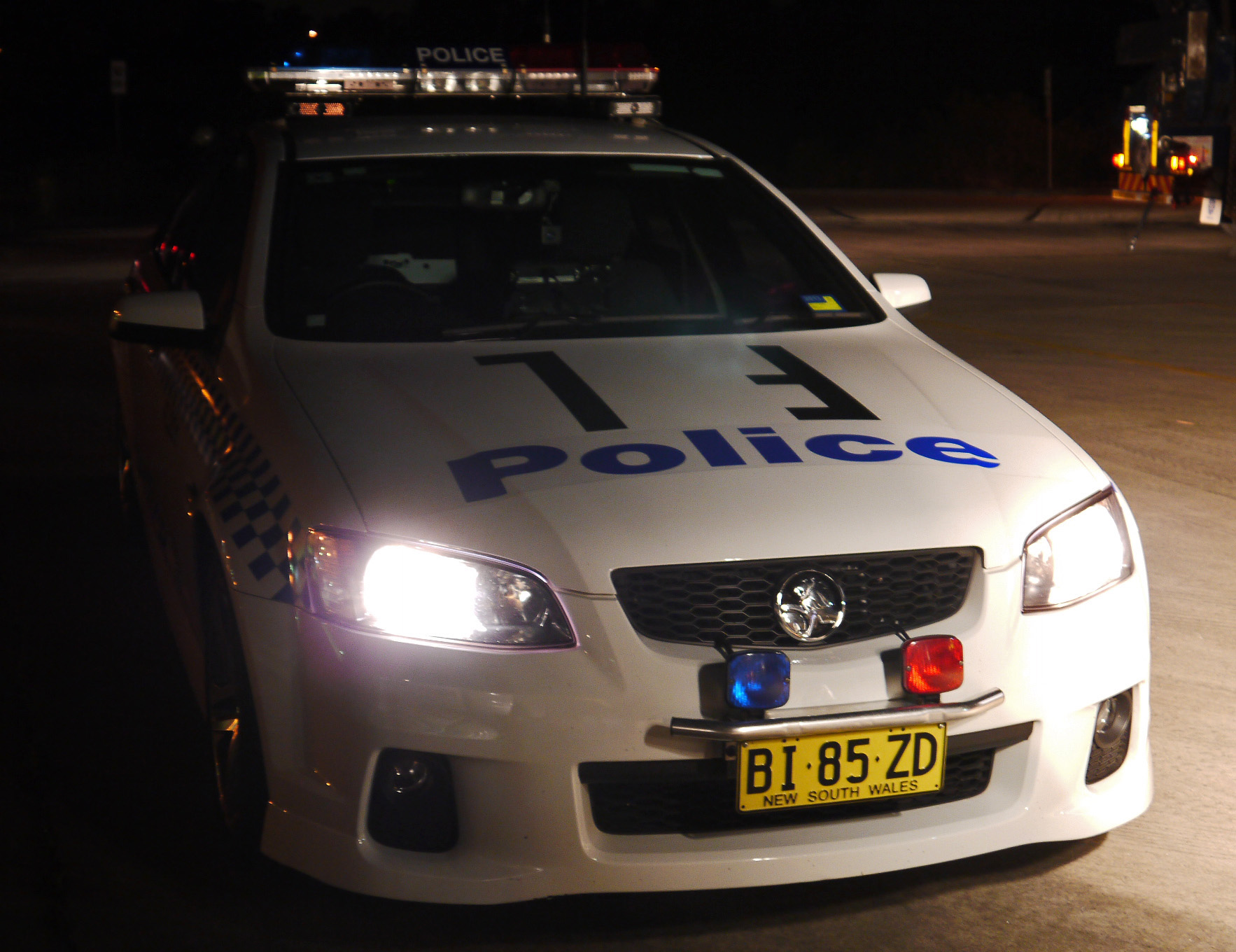 a police car is parked at night in the street