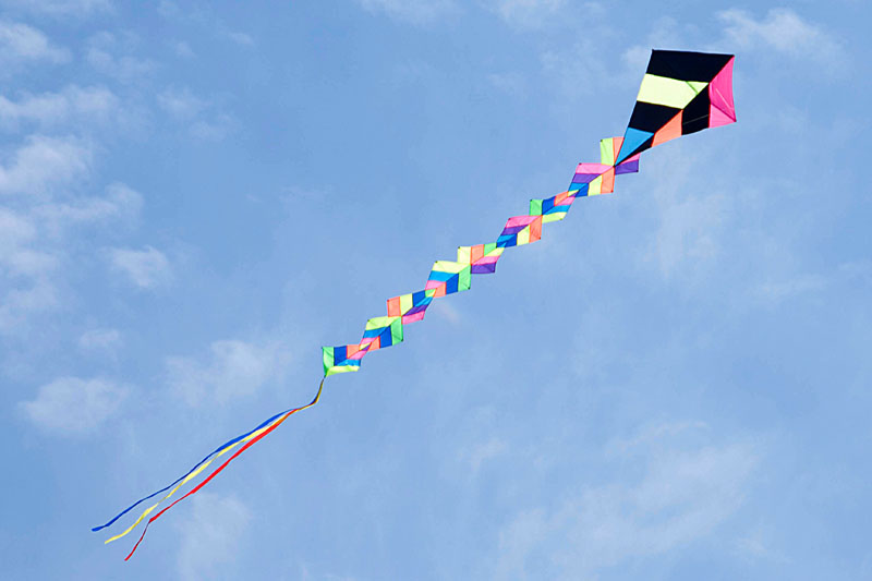 a kite is flying high in the air