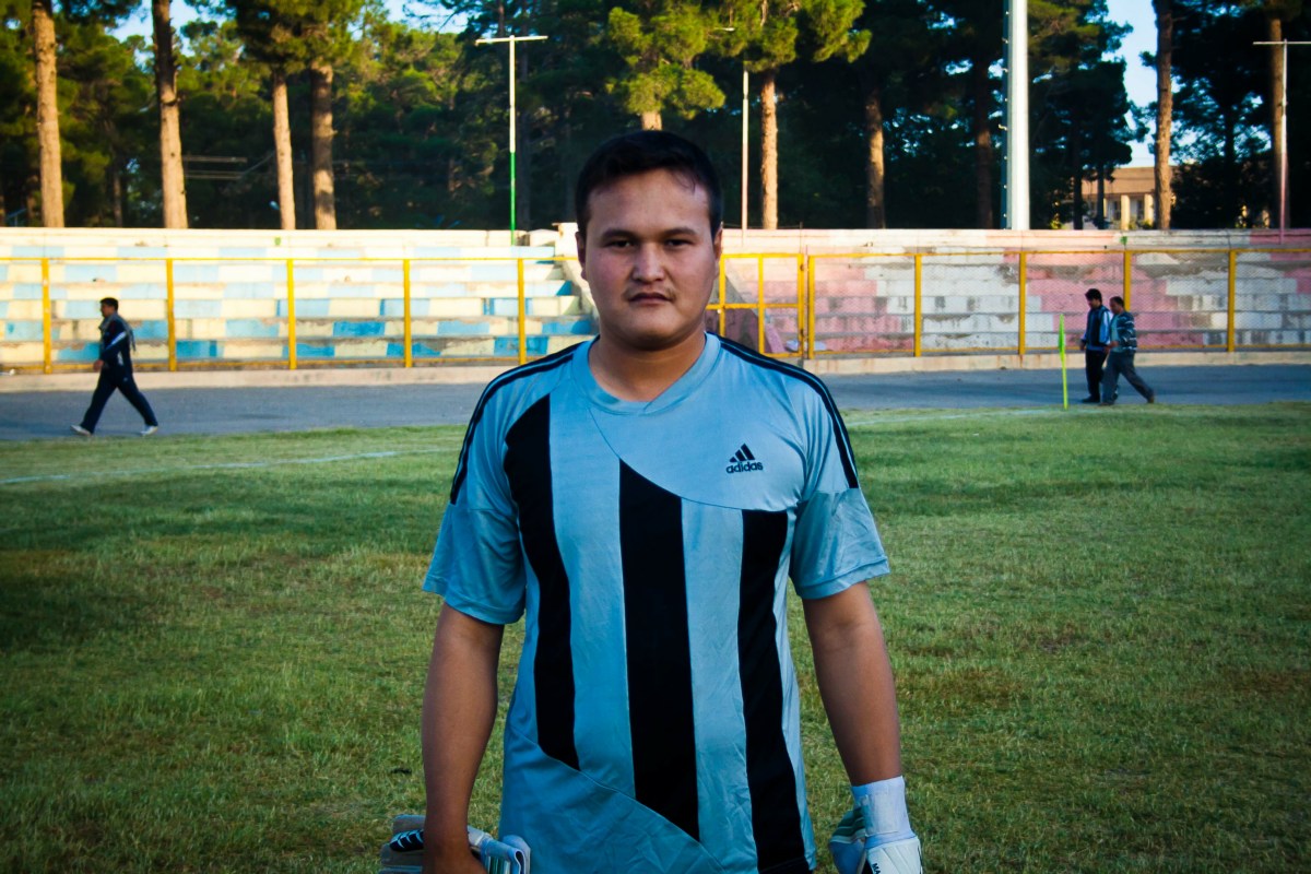 there is a man in a blue and black soccer uniform