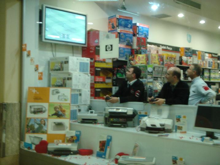 several men standing behind a counter with items on it