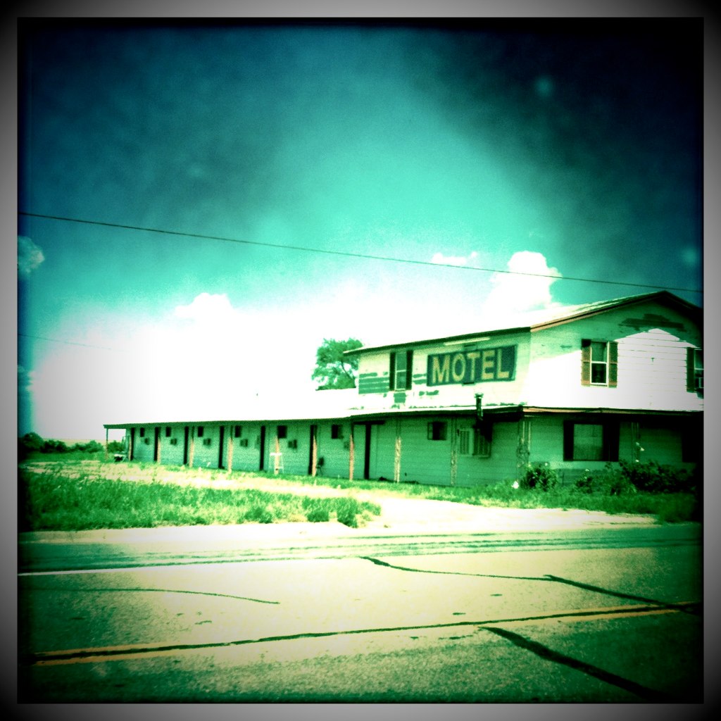 a old motel is standing empty by some road