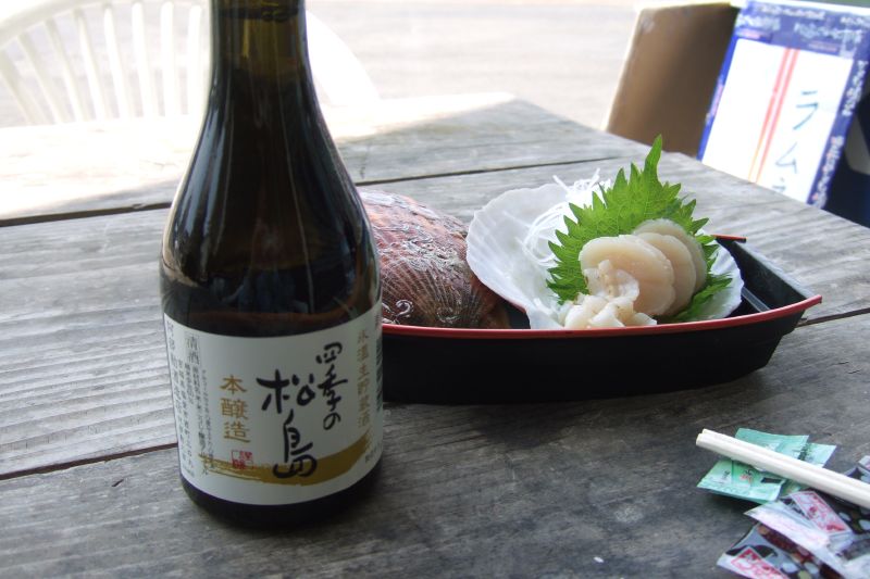 a bottle and some food sit on a table