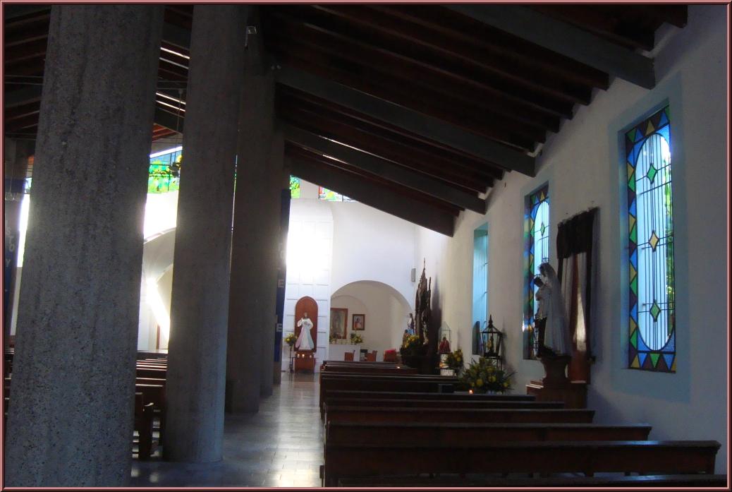 the inside of a church looking through the pews