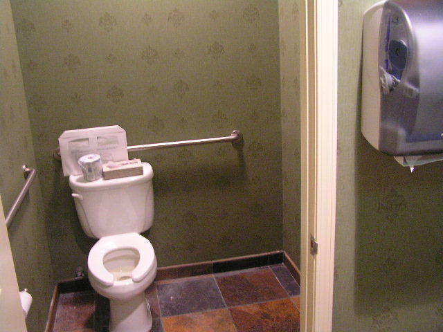 this is a clean public restroom with a white toilet