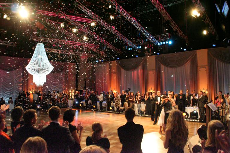 an indoor wedding ceremony with a large crowd