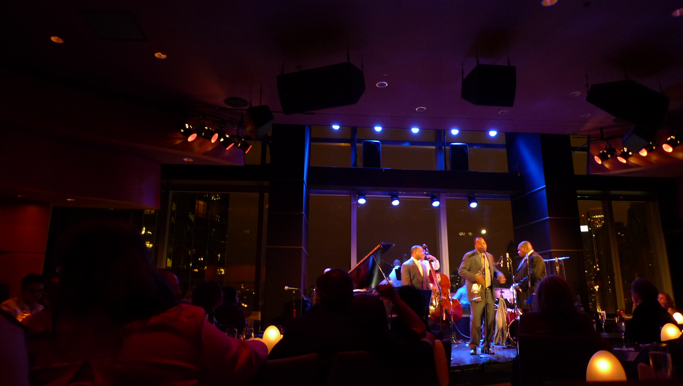 several musicians performing on stage while in the dark