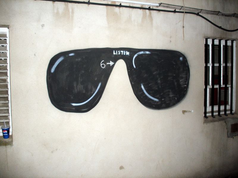 the sunglasses that was painted on a wall are marked with numbers