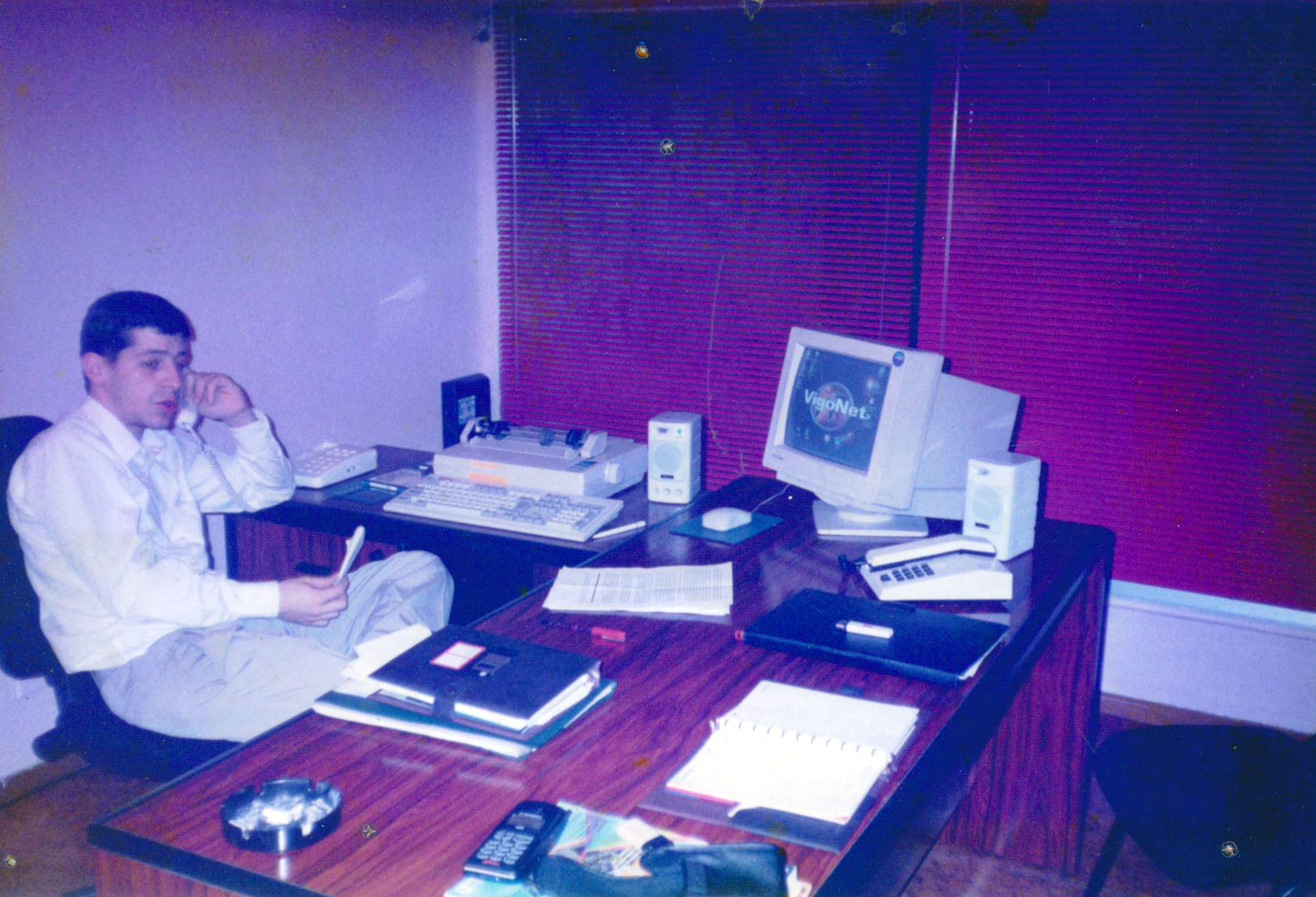 a man that is sitting at a desk in an office