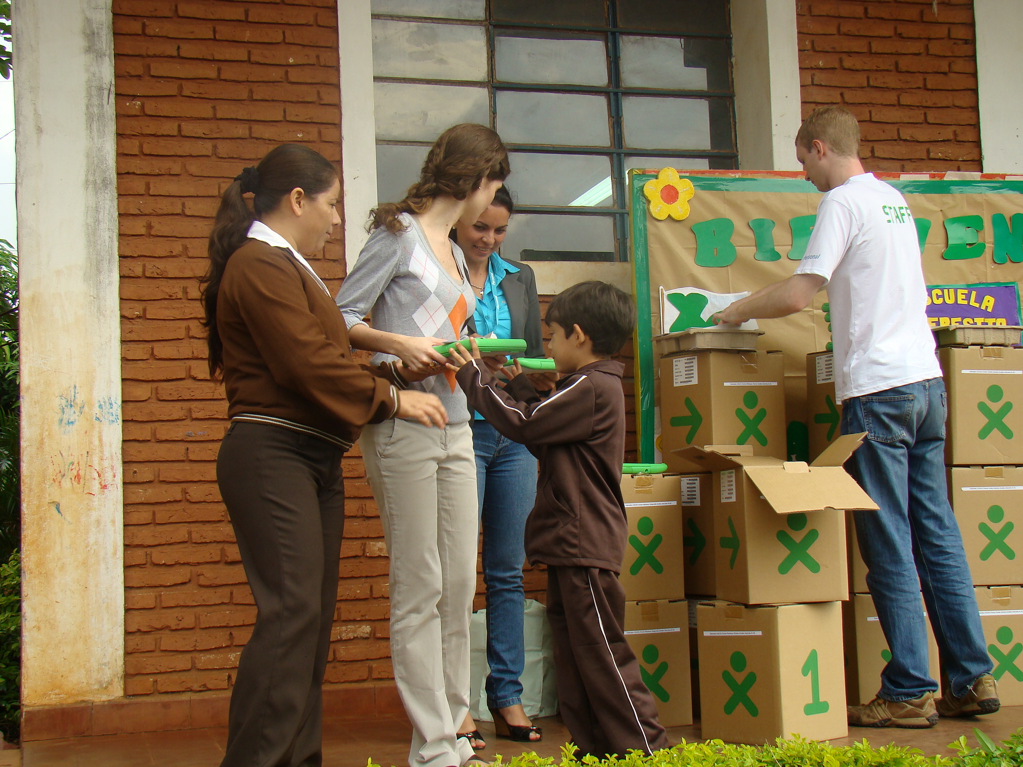 a group of people hanging out around boxes and boxes