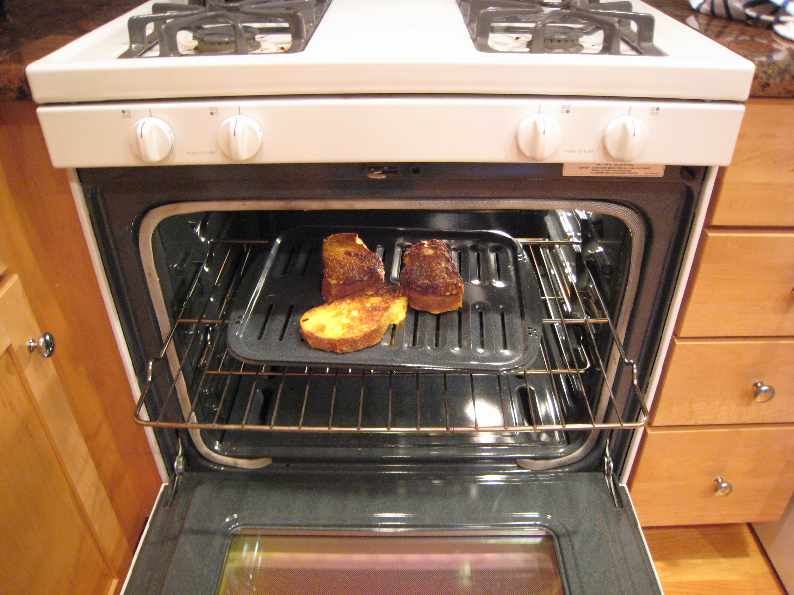 two pieces of meat cooking in an oven