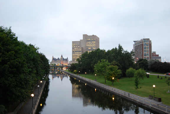 a city with tall buildings and some lights around the river