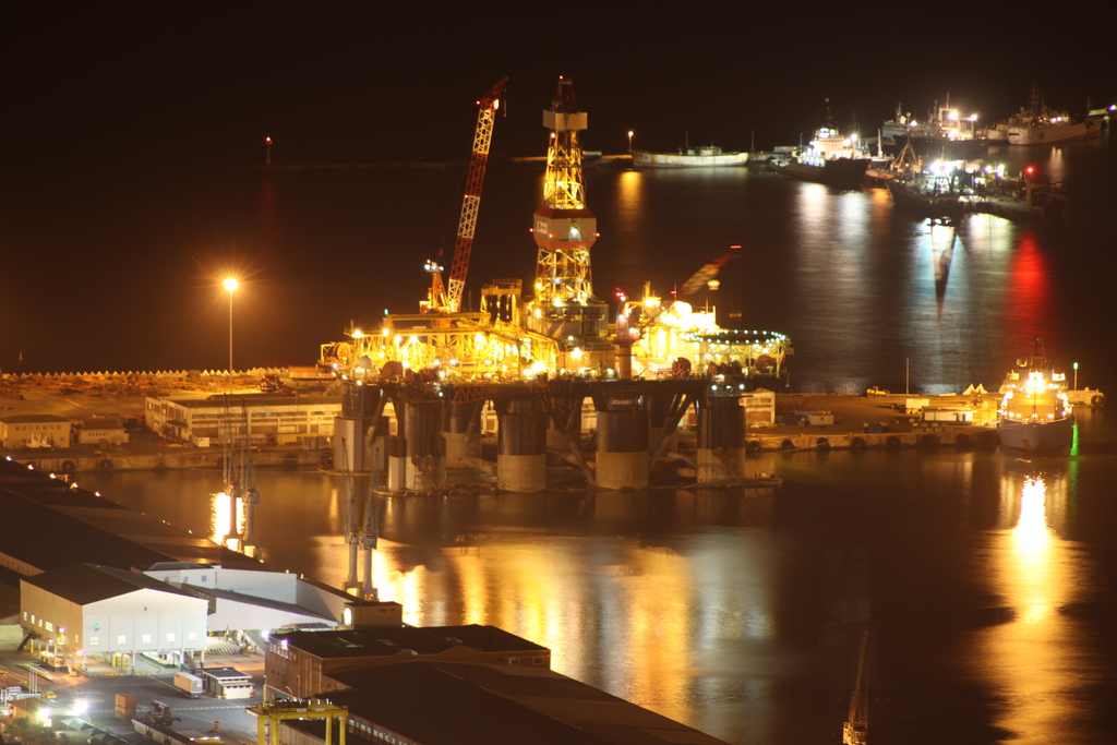 many large ships sit in the harbor during the night