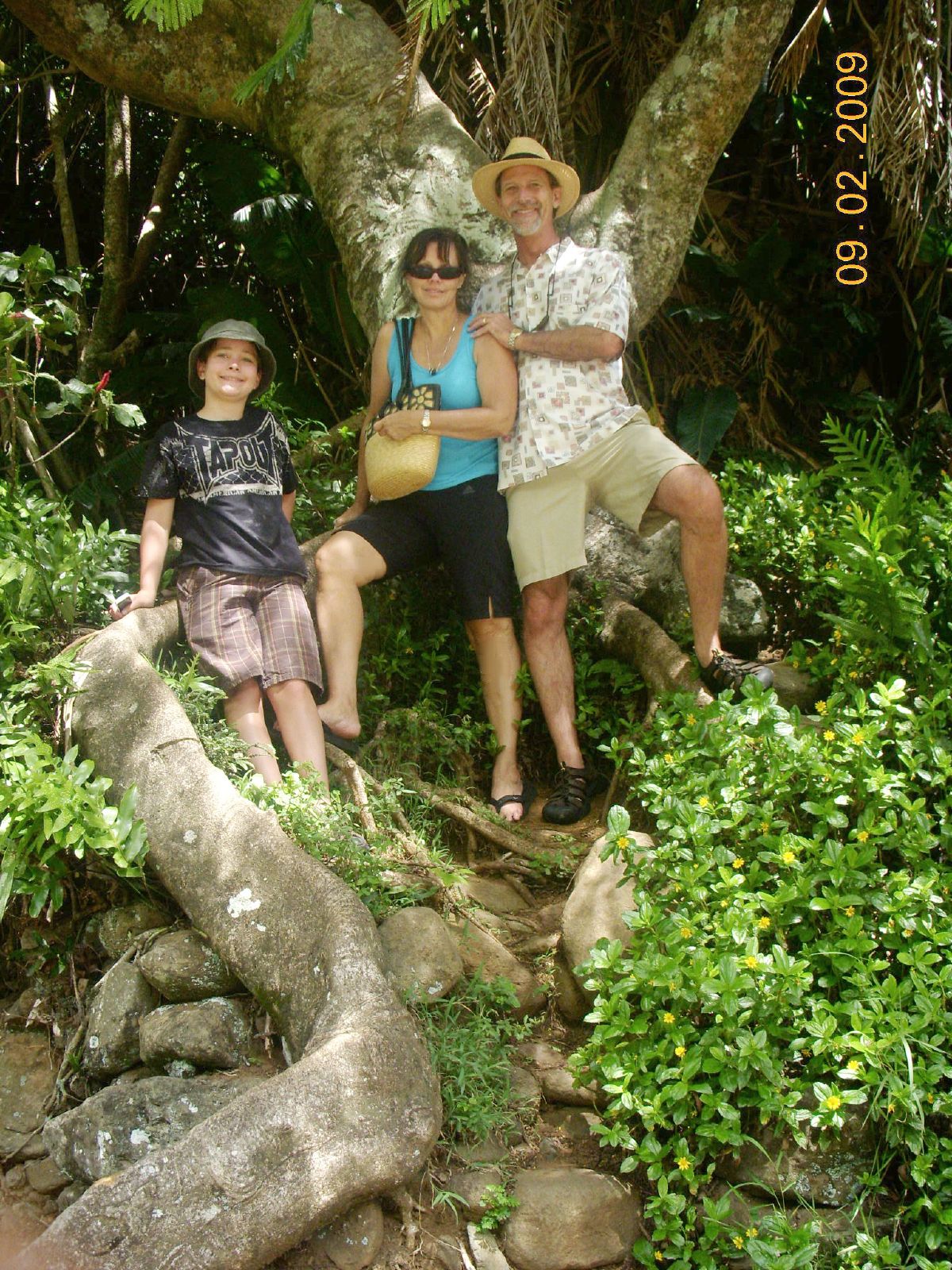 two people sitting on a rock outcropping