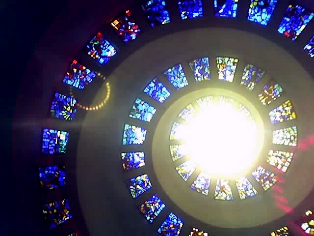 a window with stained glass and the center bright