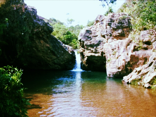 a waterfall is pouring water onto a river