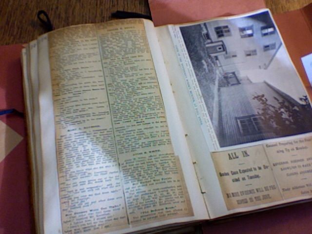 an open newspaper showing an old po