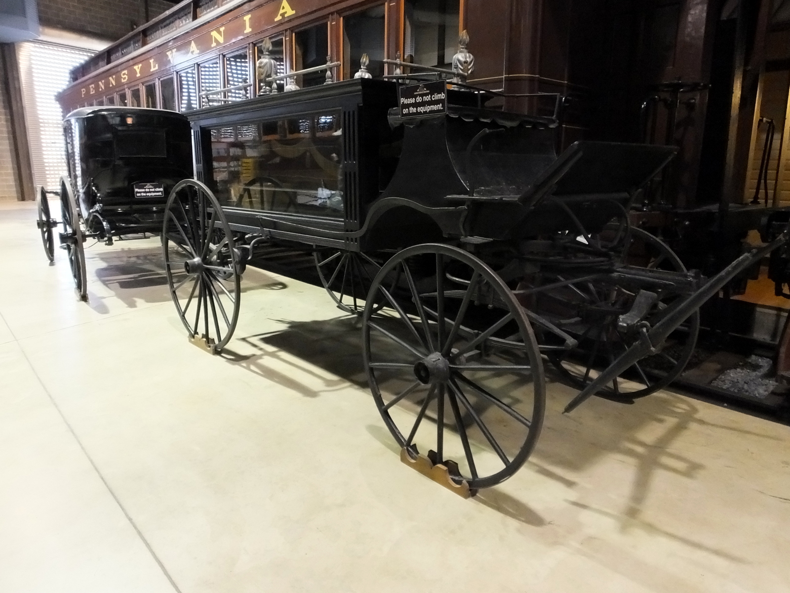 an old black carriage with some people on it
