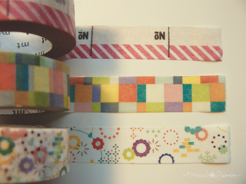 three rolls of colorful washi tapes are sitting together