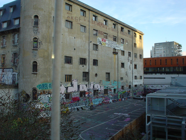 an old building with graffiti and windows