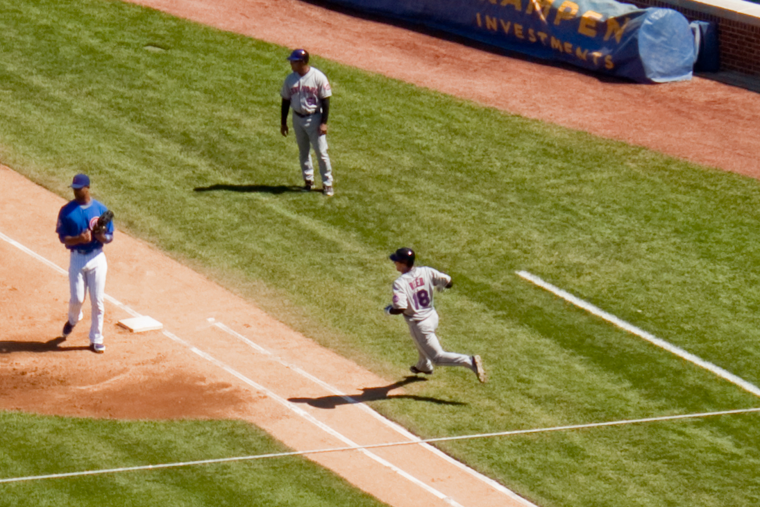 an on deck baseball player is running from first base