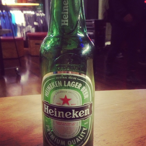 this is an empty heineken beer bottle on a table