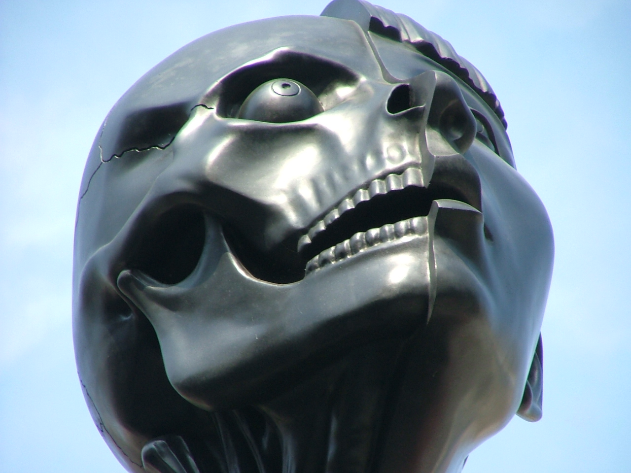 a statue of a skull and its face in the air