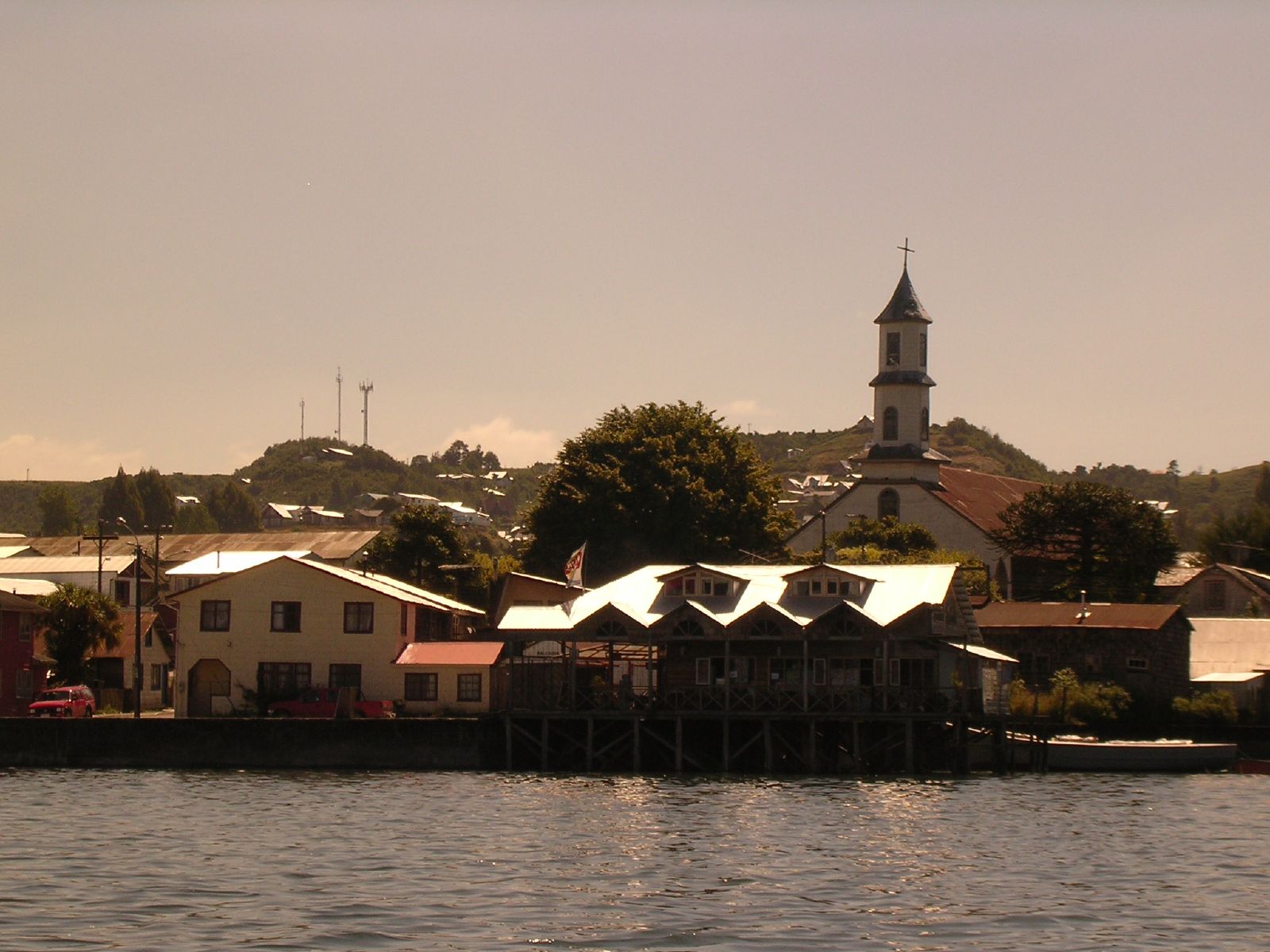 a lake with buildings and a clock tower