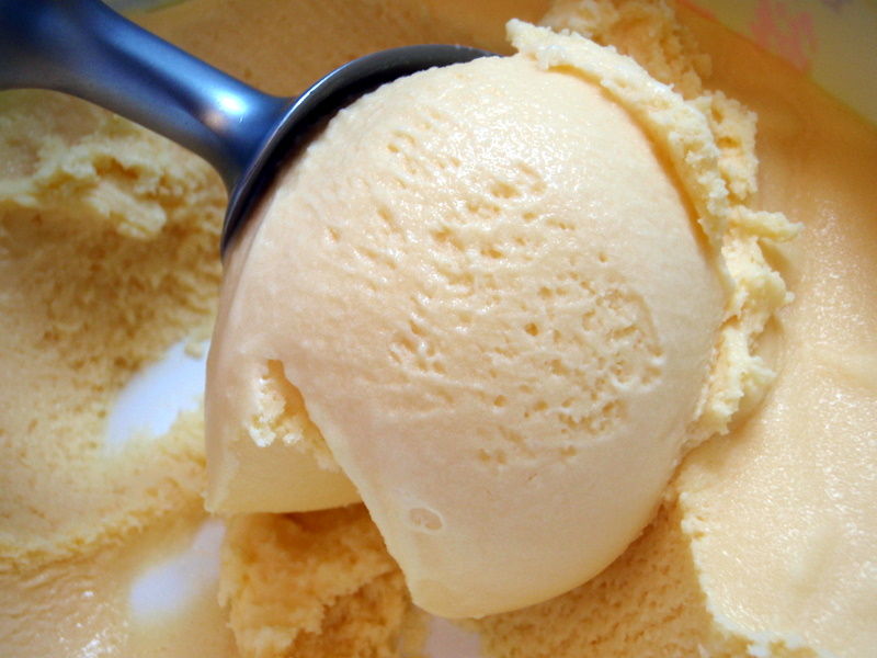 scooping ice cream in a bowl with sugar