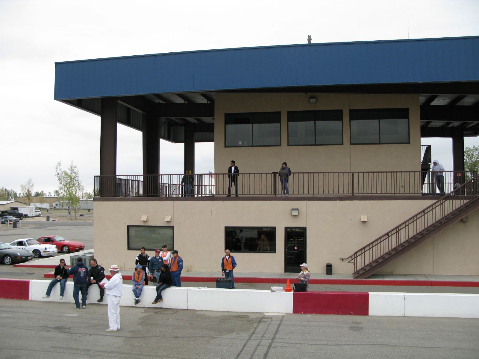 people walking in the parking lot outside of a building