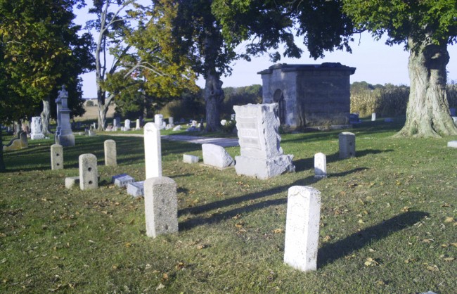 a couple of cement tombstones in a cemetery