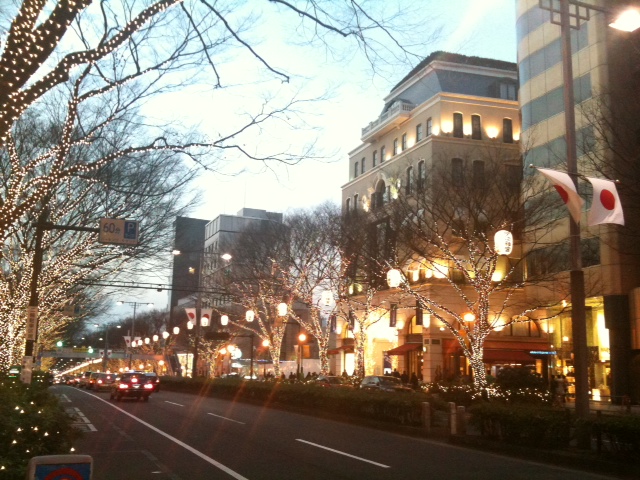 cars parked on a street by some tall buildings