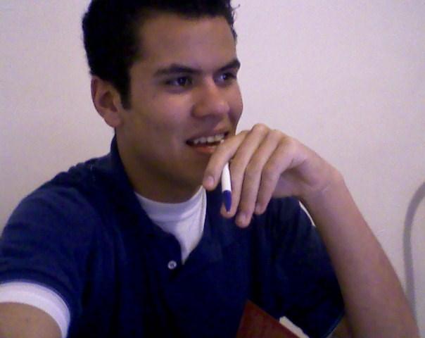 a man in blue shirt holding a tooth brush