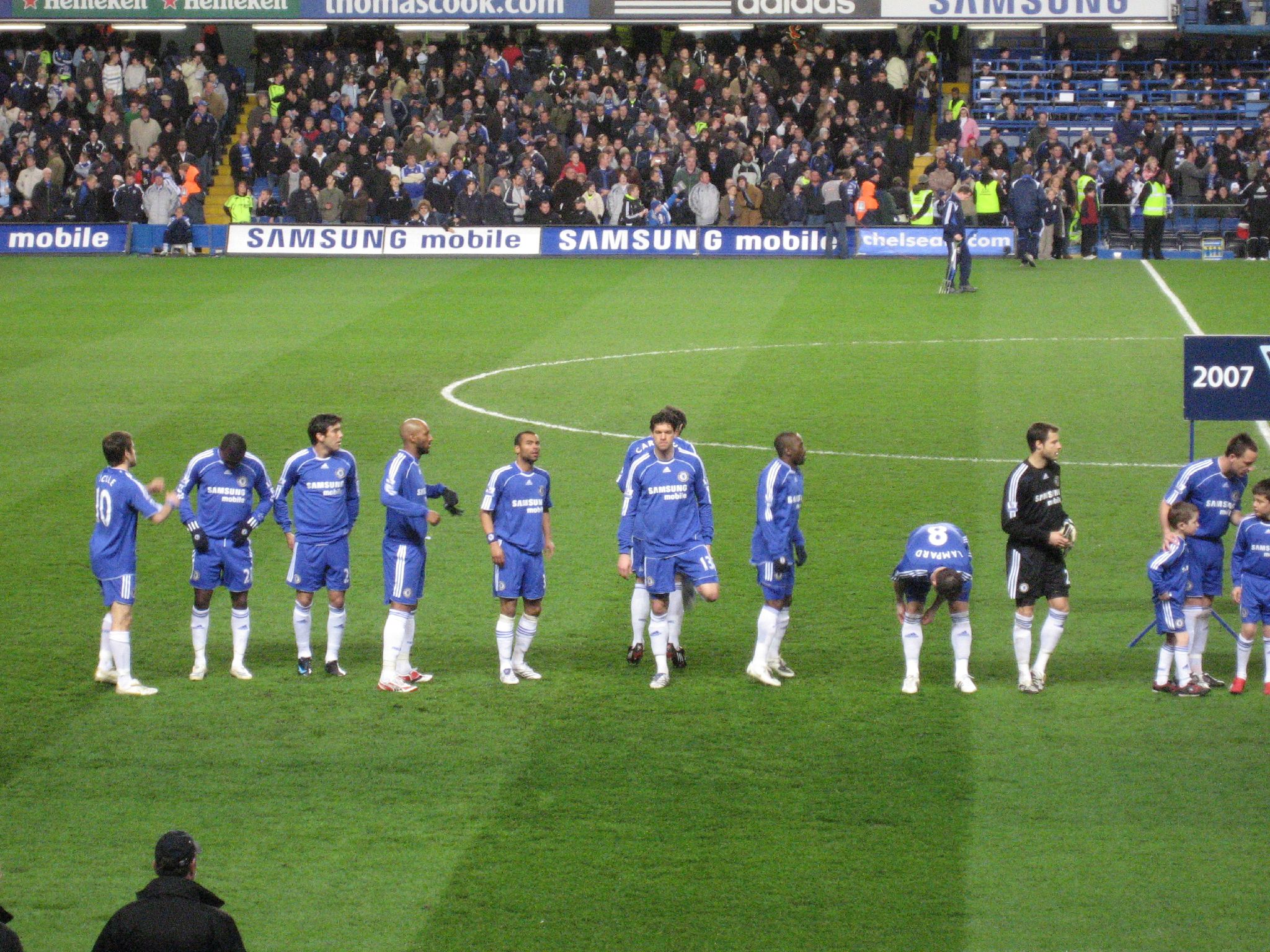 the soccer team stands on the field in formation