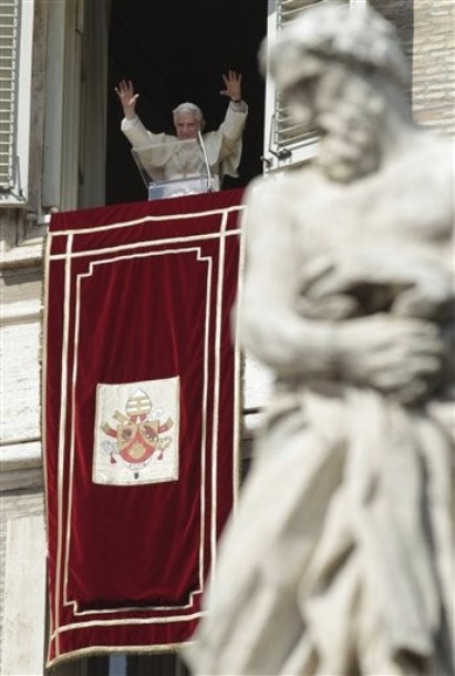 a religious man is waving in front of a crowd