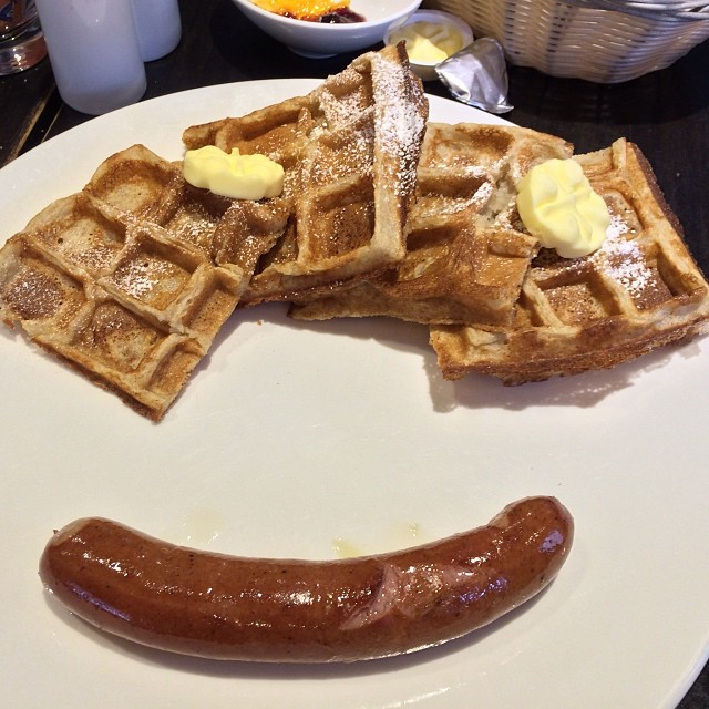 a sausage and waffles is cut into the shape of a smile