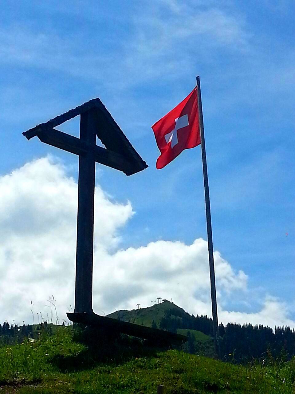 a cross in a field with a red flag