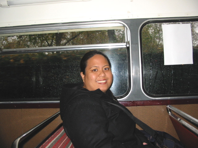 a woman smiling while on a subway train