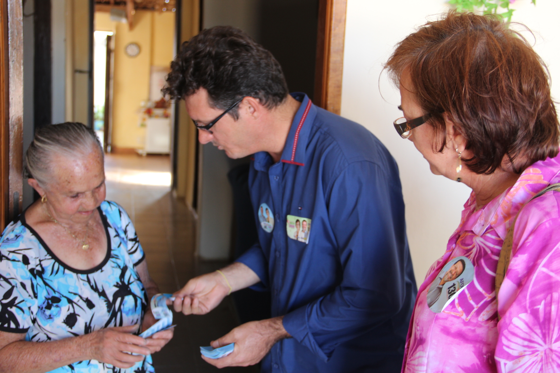 a woman looking at a phone with two people