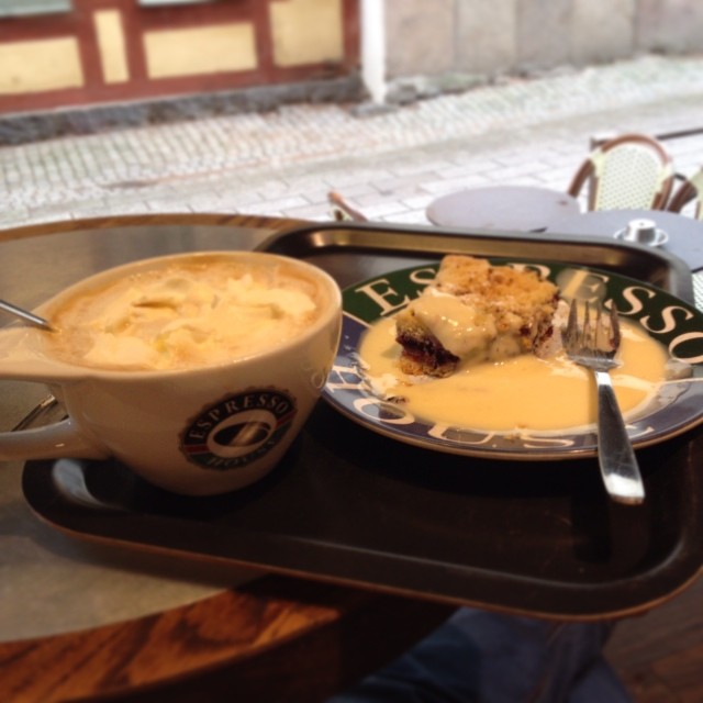 a table topped with a cup and plate filled with food