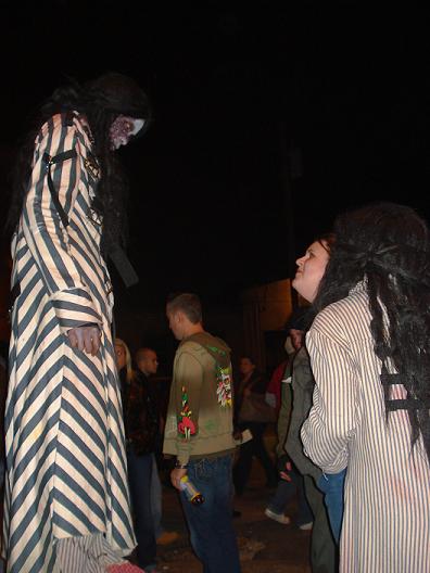 two mannequins in costumes are standing on the street