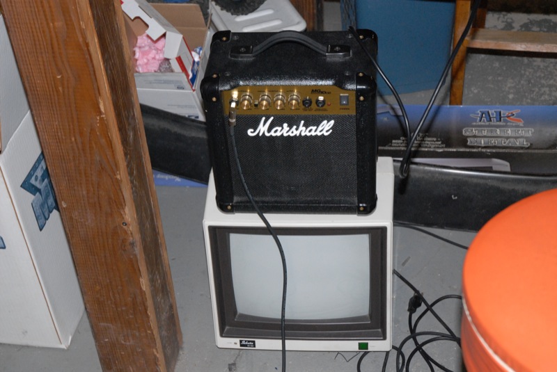 an old television with a marshall amp on top of it