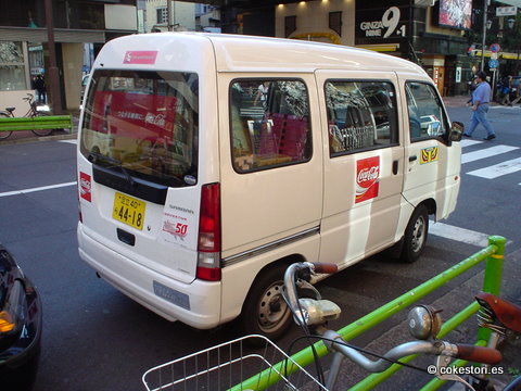 a small white van parked on the side of a street