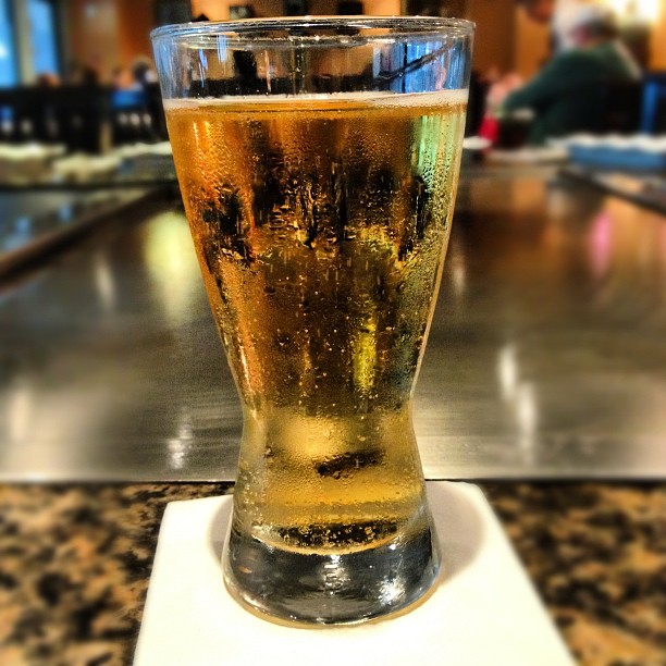 a cold beer in a glass sits on the table