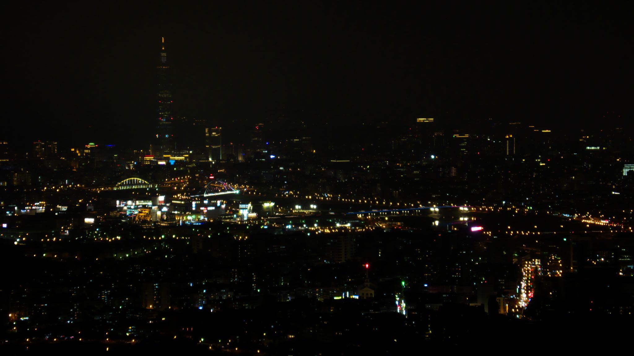 a city night scene with skyscrs lit up at different times