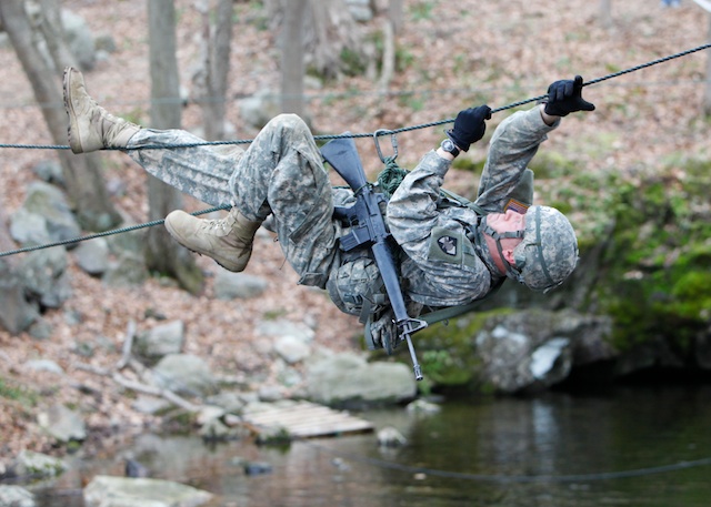 a soldier is walking along a high line