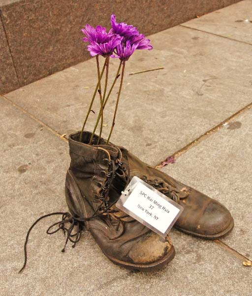 a pair of boots with flower on them sitting next to each other