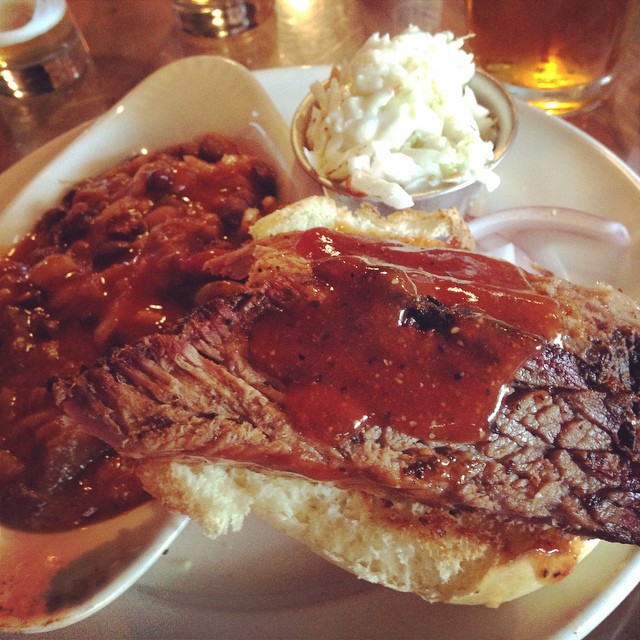 this is a plate of steak, beans and coleslaw