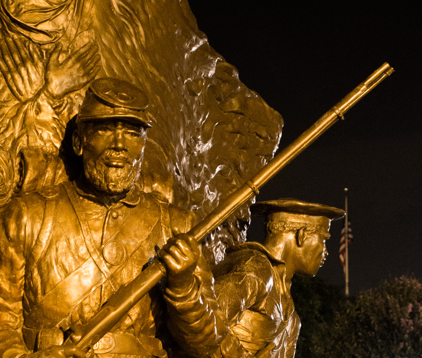 a statue holding a shovel and walking next to another man