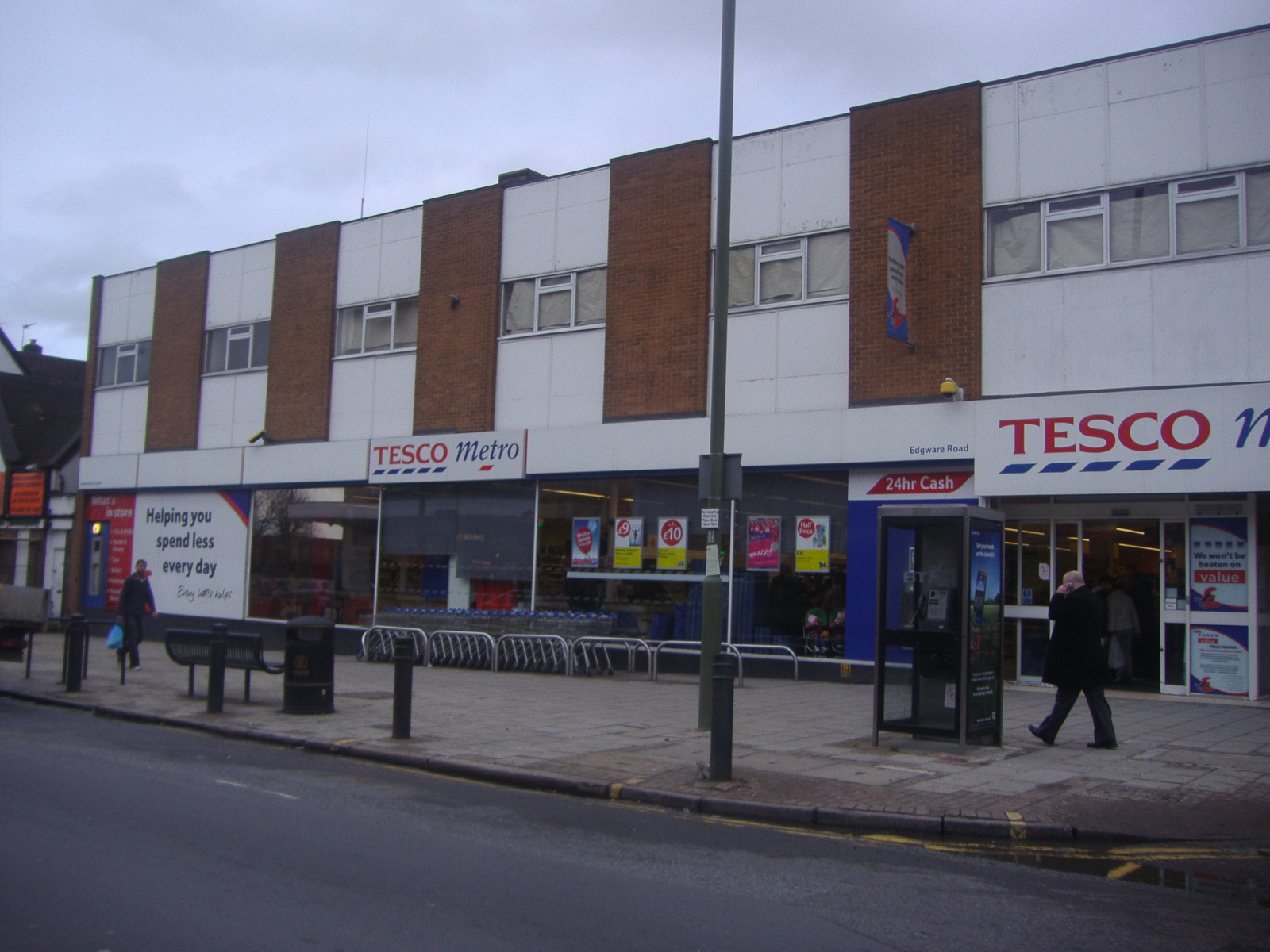 a store with two people walking by it