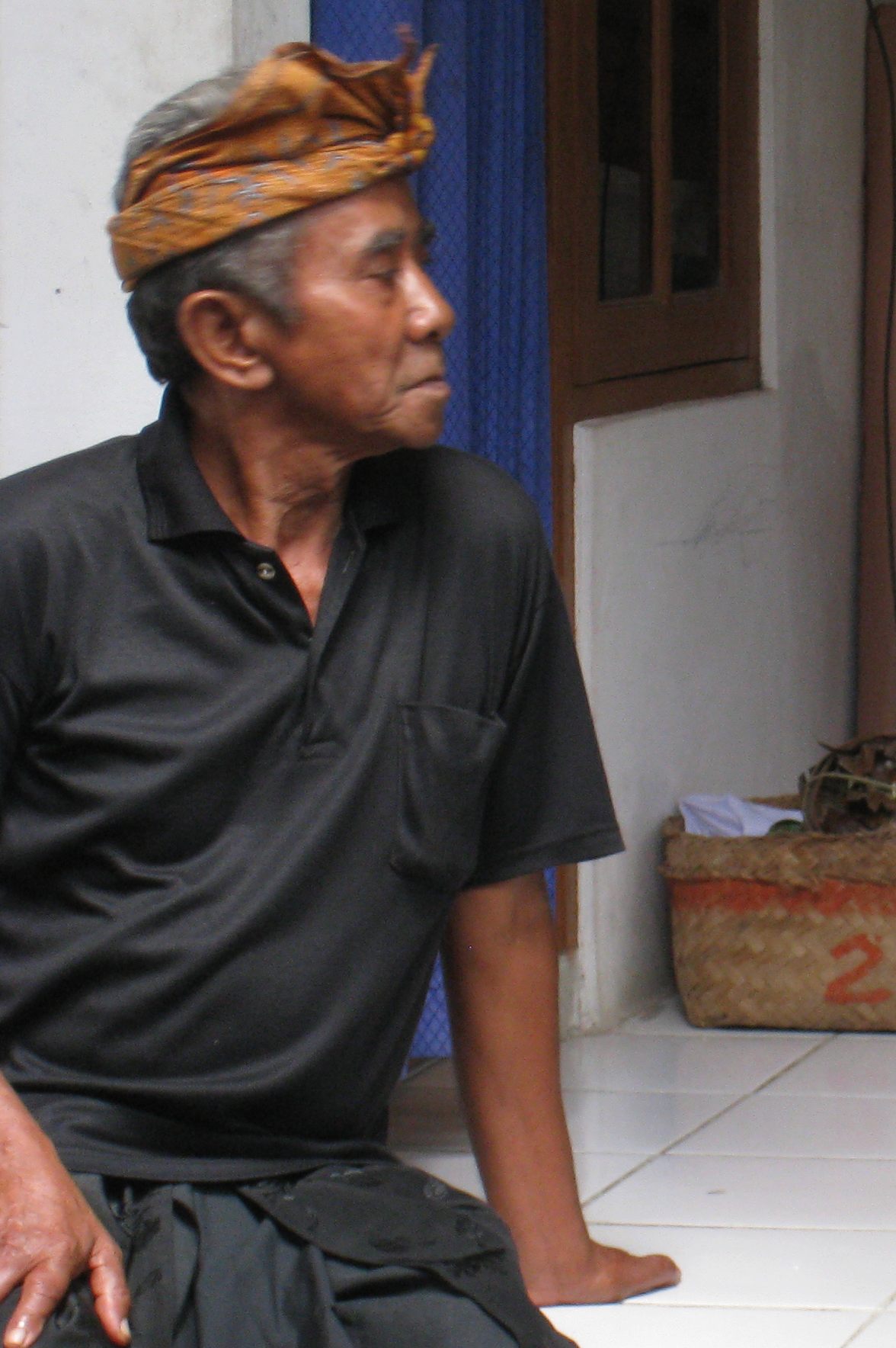 a man in a black shirt is sitting on the floor